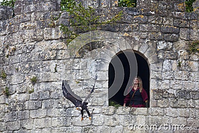 Medieval falconer and her bald eagle Editorial Stock Photo